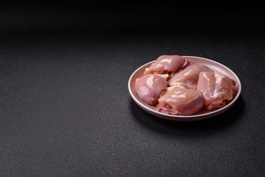 Chicken thigh fillet raw, skinless, boneless, poultry legs with salt and spices