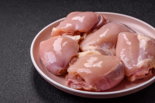 Chicken thigh fillet raw, skinless, boneless, poultry legs with salt and spices