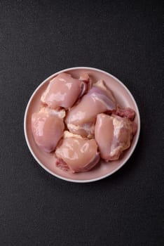 Chicken thigh fillet raw, skinless, boneless, poultry legs with salt and spices