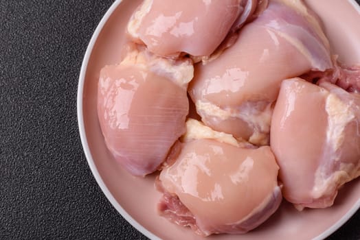 Chicken thigh fillet raw, skinless, boneless, poultry legs with salt and spices