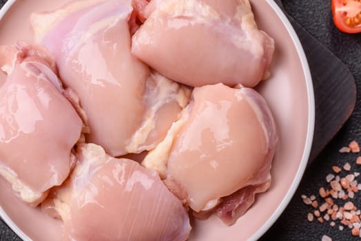 Chicken thigh fillet raw, skinless, boneless, poultry legs with salt and spices