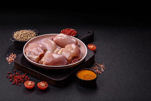 Chicken thigh fillet raw, skinless, boneless, poultry legs with salt and spices
