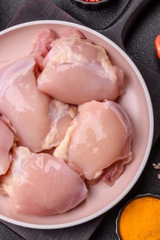 Chicken thigh fillet raw, skinless, boneless, poultry legs with salt and spices