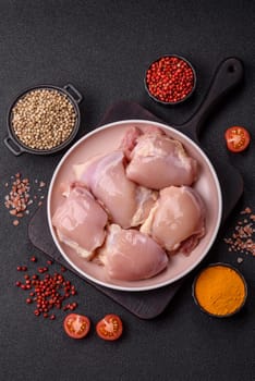 Chicken thigh fillet raw, skinless, boneless, poultry legs with salt and spices