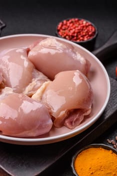 Chicken thigh fillet raw, skinless, boneless, poultry legs with salt and spices