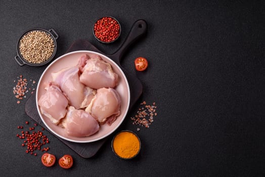 Chicken thigh fillet raw, skinless, boneless, poultry legs with salt and spices