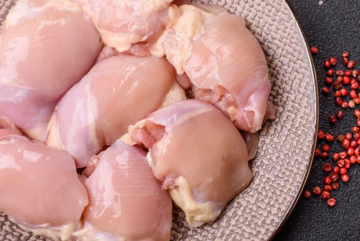 Chicken thigh fillet raw, skinless, boneless, poultry legs with salt and spices