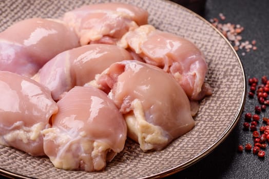 Chicken thigh fillet raw, skinless, boneless, poultry legs with salt and spices