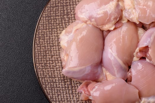 Chicken thigh fillet raw, skinless, boneless, poultry legs with salt and spices