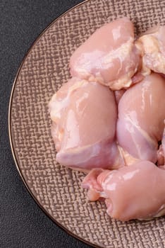 Chicken thigh fillet raw, skinless, boneless, poultry legs with salt and spices