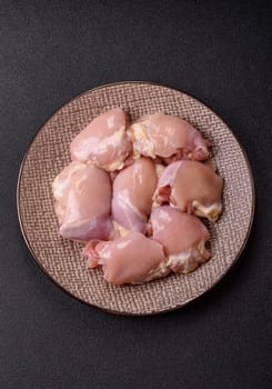 Chicken thigh fillet raw, skinless, boneless, poultry legs with salt and spices