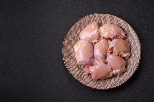 Chicken thigh fillet raw, skinless, boneless, poultry legs with salt and spices
