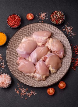 Chicken thigh fillet raw, skinless, boneless, poultry legs with salt and spices