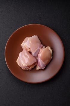 Chicken thigh fillet raw, skinless, boneless, poultry legs with salt and spices