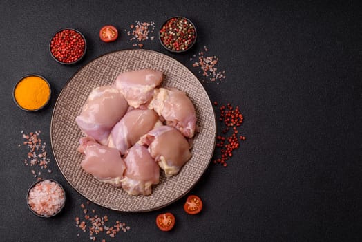 Chicken thigh fillet raw, skinless, boneless, poultry legs with salt and spices