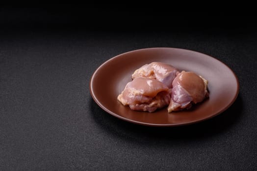 Chicken thigh fillet raw, skinless, boneless, poultry legs with salt and spices