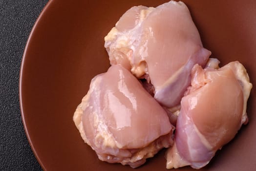 Chicken thigh fillet raw, skinless, boneless, poultry legs with salt and spices