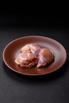 Chicken thigh fillet raw, skinless, boneless, poultry legs with salt and spices