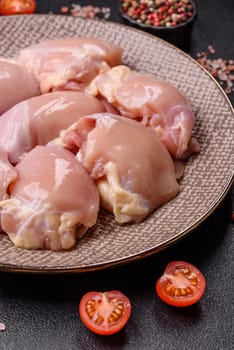 Chicken thigh fillet raw, skinless, boneless, poultry legs with salt and spices