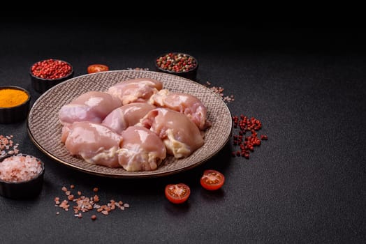 Chicken thigh fillet raw, skinless, boneless, poultry legs with salt and spices