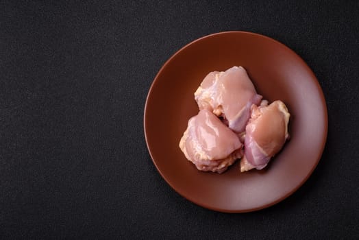 Chicken thigh fillet raw, skinless, boneless, poultry legs with salt and spices