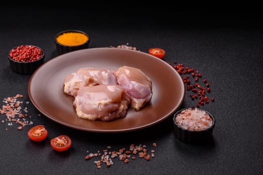 Chicken thigh fillet raw, skinless, boneless, poultry legs with salt and spices
