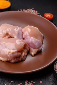 Chicken thigh fillet raw, skinless, boneless, poultry legs with salt and spices