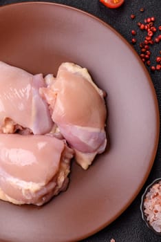 Chicken thigh fillet raw, skinless, boneless, poultry legs with salt and spices