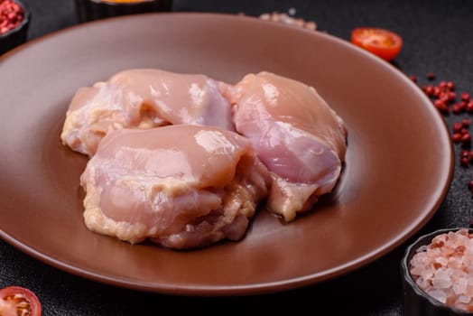 Chicken thigh fillet raw, skinless, boneless, poultry legs with salt and spices