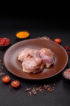 Chicken thigh fillet raw, skinless, boneless, poultry legs with salt and spices