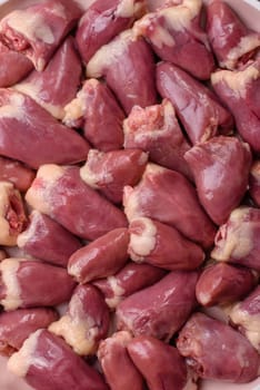 Chicken raw heart, red duck or turkey internal organs as an ingredient for dinner preparation