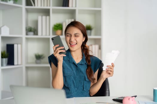 The woman expresses joy as she receives good financial news, celebrating her financial planning success and engaging with her records.