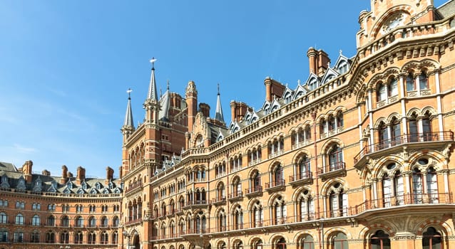 London, UK - Apr 11, 2025 - Stunning of the gothic building where the St. Pancras Renaissance Hotel is based in Kings Cross. Facade of Victorian architecture at the Midland Grand Hotel, use it as your Wallpaper, Poster and Space for text, Selective focus.