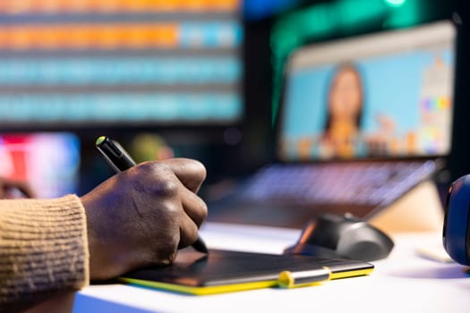 African american graphic designer working on photo retouching project on dual monitors in a modern office setting at his home. Man showcasing creativity in digital editing software.