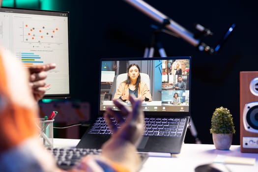 African american man employee having a video call with colleagues while working from home office. Coworkers engaged in a discussion utilizing technology for virtual communication.
