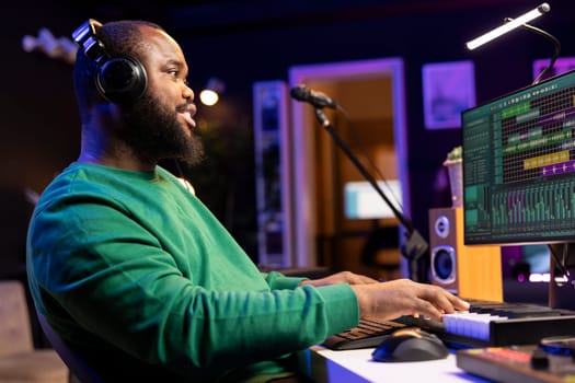 Music producer adding piano notes as tunes for a new melody, recording sounds on electronic synthesizer. Songwriter audio engineer editing and mixing soundtracks on a digital software.