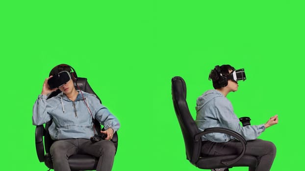 Gamer winning and losing at video games console tournament, using virtual reality interactive glasses against greenscreen backdrop. Woman feeling sad and happy about victory or failure. Camera B.
