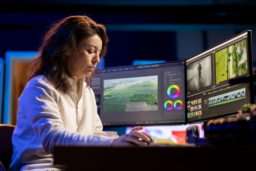 Videographer at work in creative media agency office, ready to start color correcting raw footage. Video editor editing video renders, using software to make montage from clips