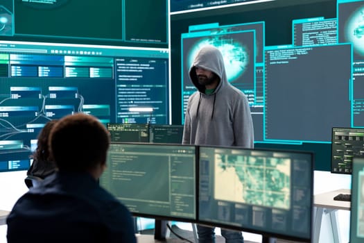 Cyber security expert in a national safety operations center detecting cyber attacks or threats. Governmental hacking team focusing on data protection, cyber operations in progress.