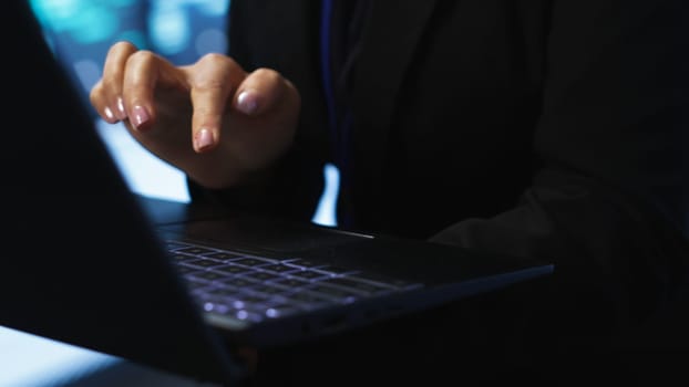Programmer in server hub checking recovery plan on laptop, monitoring energy consumption across mainframes. Close up of employee using notebook in data center, ensuring rigs are functioning, camera A