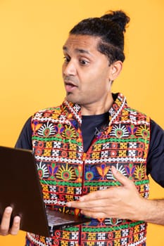 Stupefied person gasping after seeing error message on laptop screen while doing job tasks, studio background. Employee feeling speechless after receiving confusing decision on mail