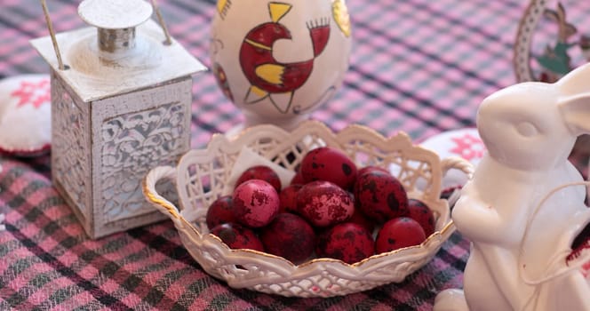 Decorations for Easter include vibrant eggs, a sweet bunny figurine, and a charming lantern, creating a delightful spring home decor arrangement perfect for seasonal celebrations.