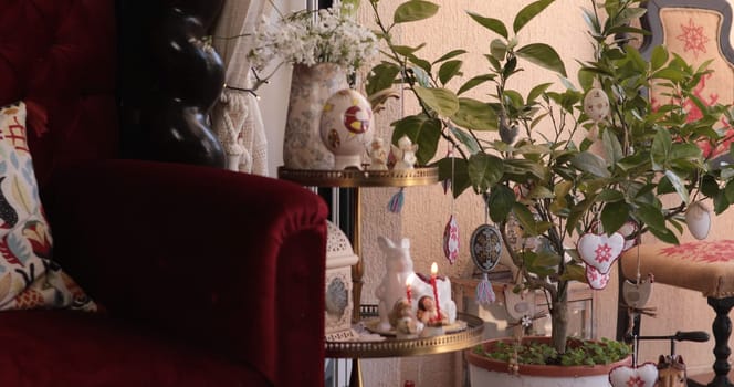 A welcoming living room decorated for Easter features colorful decorations, plants, and cozy furnishings.
