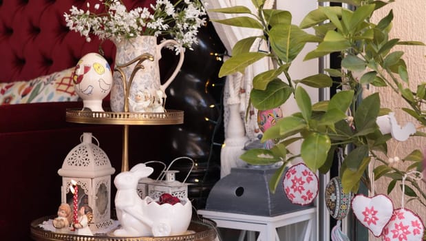 Bright colors and charming Easter decorations fill the living room with spring home decor. A decorative tiered stand displays festive items, adding joy to the space in a cozy, welcoming environment.
