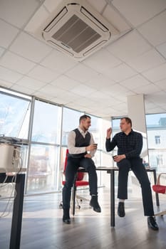 Colleagues drinking coffee in the office