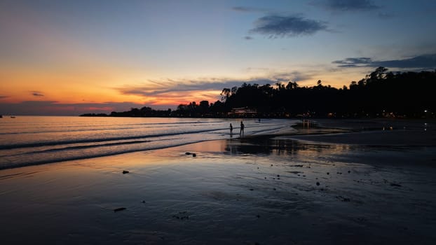 Stunning sunset colors painting the sky over a tranquil beach, with the wet sand reflecting the vibrant hues and a yacht sailing peacefully on the calm sea, creating a serene and picturesque scene
