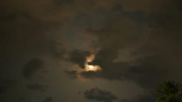 Two dark clouds forming a heart shape with the moon in between, surrounded by stars in a dark night sky, creating a romantic and dreamy atmosphere
