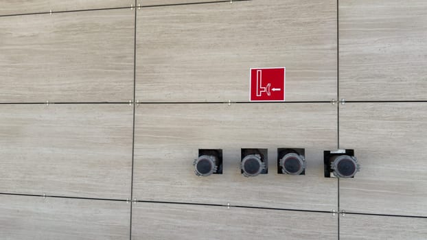 Fire extinguishing pipe connection system. Wall sign indicating location of fire engine connection to dry water supply in an emergency. Dry water system for building safety in fire