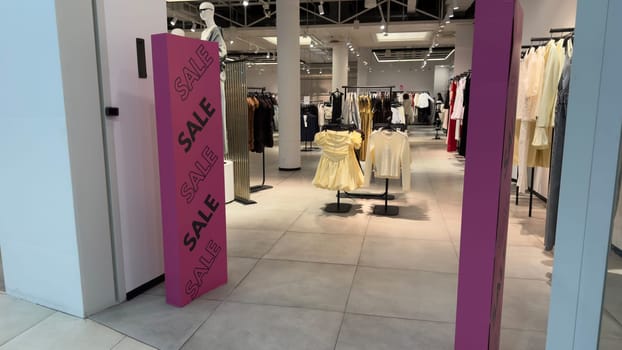 Sale in clothing store. Big discounts for shopping. Entrance to clothing and accessories store with magnetic panels decorated with the words sale. Marketing and attracting customers with discounts