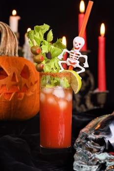 Bloody Mary cocktail. Tomato juice and vodka, garnished with celery stalk, lime and olives. Halloween party ideas